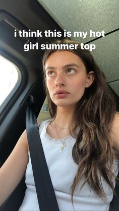 a woman sitting in the back seat of a car with her hand on her hip