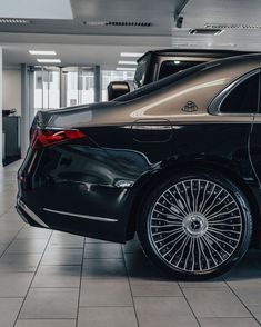 a black car is parked in a building