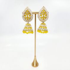 Introduce traditional charm to any event with Savina Jhumka Earrings. These yellow earrings are lightweight and comfortable, making them perfect for mehndi, sangeet, or garba. Adorned with pearls, these jhumkas are a must-have for any jewelry collection. Add a touch of elegance and tradition to your wardrobe with Savina Jhumka Earrings! Elegant Yellow Earrings For Festivals, Elegant Yellow Festive Earrings, Elegant Yellow Chandbali Earrings, Yellow Temple Jewelry Earrings For Festivals, Yellow Earrings For Party And Festivals, Chandbali Beaded Earrings For Party And Festivals, Navratri Drop Jhumkas, Festival Chandbali Beaded Earrings For Parties, Festival Chandbali Beaded Party Earrings