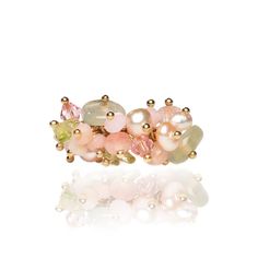 "Introducing the exquisite Mermaid Ring, a unique creation crafted with precision and care. This handmade beauty features a delicate blend of freshwater pearls, Austrian crystals, prehnite quartz, and enchanting green and pink tourmaline chips reminiscent of the ocean's allure. The ring is elegantly set on a 24-karat gold-plated adjustable band, adding a touch of sophistication. Embrace the whimsical charm of this special piece, a perfect addition to your collection or a thoughtful gift for someone dear. Dive into elegance with the Mermaid's Ring and let its beauty enchant your style. Limited availability, so secure yours now and make a splash with this captivating accessory. Style R026 This exquisite ring is crafted in the United States. Materials prehnite quartz pink freshwater pearls pi Mermaid Ring, Beauty Features, Quartz Pink, Pearl Pin, Creation Crafts, Coastal Wedding, Handmade Beauty Products, Rose Lights, Quartz Rose