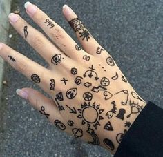 a person's hand with tattoos on it