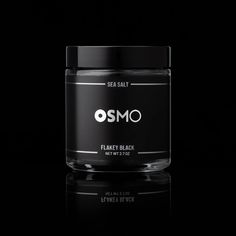 a black jar with the word osmo written on it in white lettering and an image of