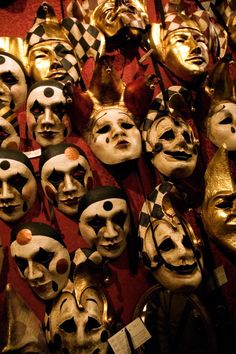 many masks are lined up on the wall