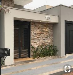 the front entrance to an apartment building with black doors