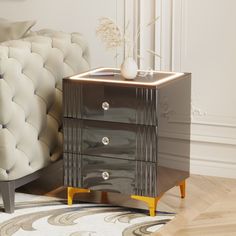 a nightstand with two drawers on top of it next to a white chair and rug