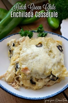 chicken enchilada casserole on a white and blue plate with parsley