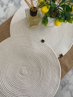 two round placemats sitting on top of a table