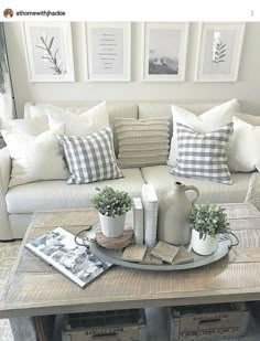 a living room filled with furniture and pillows on top of a coffee table in front of a window