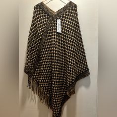 Pretty 100% Acrylic Poncho, Cozy And Warm For Those Chilly Fall Days Ahead. . One Size Fits All. Poncho Measures Approximately 39” In Length. Color Is Beige/Black. Smoke Free Home. Brown Fringed Poncho For Fall, Brown Fringe Poncho For Fall, Brown One Size Poncho With Fringe, One Size Brown Fringe Poncho, Brown Fringe One Size Poncho, One Size Brown Cape For Fall, One-size Brown Cape For Fall, Oversized Brown Cape Shawl, Brown Shawl Cape For Fall