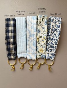 four different colors of fabric with gold handles on each side and the words baby blue, ocean charm