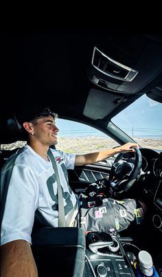 a man sitting in the driver's seat of a car