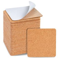 cork coasters with white paper sticking out of them on a white background, set of 4