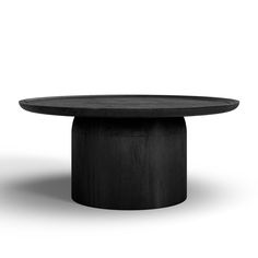 a round table with black wood on the top and bottom, sitting in front of a white background