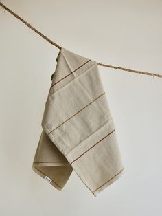 two folded towels hanging on a clothes line