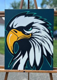 an eagle painted on a easel in front of a house