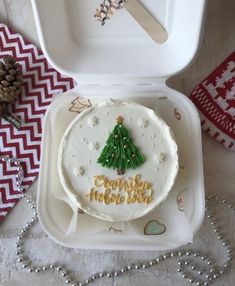 a white cake with a christmas tree on it