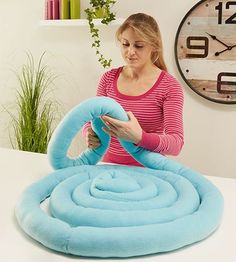 a woman is working on an inflatable object that looks like a spiralle