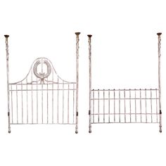 two white iron beds with posts on each side