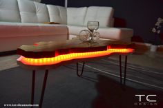 a coffee table with lights on it and a glass sitting on top of the table