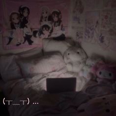 a laptop computer sitting on top of a bed covered in blankets and pillows with anime wallpapers behind it