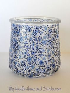 a blue and white planter sitting on top of a table