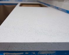 a white counter top with blue tape around it