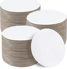 white plates stacked on top of each other in front of a white background with brown stripes