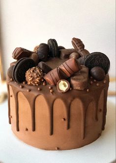 a cake with chocolate frosting and cookies on top