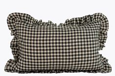 a black and white checkered pillow with ruffled edges