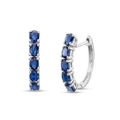 Add a fun pop of color to your attire with these gemstone huggie hoop earrings. Fashioned in sterling silver, each hoop showcases a row of 4.0 x 3.0mm oval-shaped bright blue sapphires. Buffed to a brilliant luster, these earrings secure with lever backs. Sterling Silver Gemstone Huggie Earrings, Classic Sterling Silver Hoop Earrings With Gemstone, Fine Jewelry Oval Huggie Earrings With Prong Setting, Classic Sterling Silver Gemstone Hoop Earrings, Oval Sterling Silver Huggie Earrings For Gift, Oval Sterling Silver Huggie Earrings As Gift, Sapphire Sterling Silver Hoop Earrings, Blue Sterling Silver Huggie Earrings, Oval Huggie Earrings Fine Jewelry