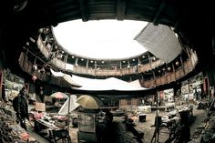 the inside of a building with many tables and chairs