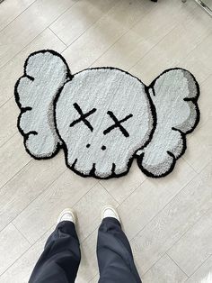 a person standing in front of a rug with an elephant on it