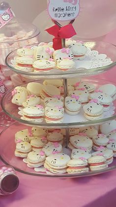 there is a three tiered tray with hello kitty cupcakes on it and other treats