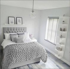 a bedroom with pink and gray bedding