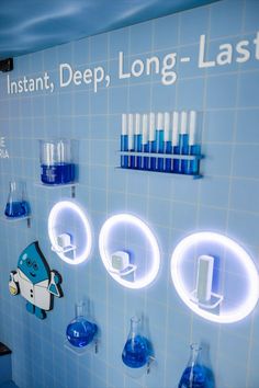 Laneige's science lab wall design inside a branded bus for an immersive pop up experience. Expo West, Brand Activations, Interactive Walls, Experiential Marketing, Science Lab