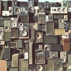 a large amount of old stereos are stacked on top of each other