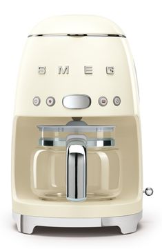 a cream colored coffee maker with the word smegle on it's side