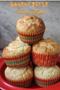 several muffins stacked on top of each other in a red bowl with the words bakery style vanilla muffins