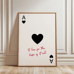 a card game with hearts and spades is displayed in front of a white wall