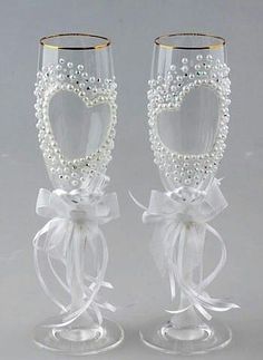 two wine glasses decorated with pearls and bows