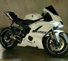 a white and black motorcycle parked in a garage