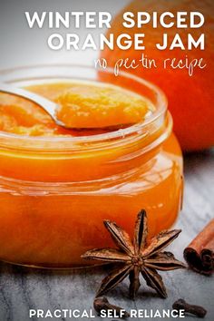 an orange jam in a glass jar with cinnamon and star anise on the side