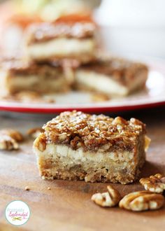 two pieces of pecan cheesecake squares on a wooden table with the title overlay