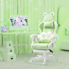 a green chair with a white cat pillow on top of it in front of a tv