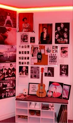 a room filled with lots of posters and pictures on the wall next to a shelf