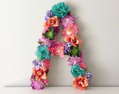 the letters are made out of flowers and have been placed on top of each other