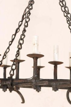 an old chandelier with five candles hanging from it's arms and chains