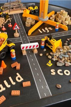 a play table with construction vehicles and blocks