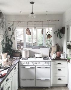 a kitchen with an oven, stove and counter tops in white painted wood flooring