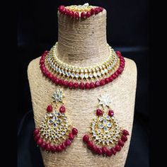 Gold Rodium Polish Red and Maroon color Necklace in Metal Alloy studded with CZ Diamond, Kundan Red Hand Set Necklaces For Festivals, Red Hand Set Kundan Necklace For Party, Red Stone Work Jewelry Sets For Gifts, Red Kundan Necklace Hand Set For Festivals, Red Kundan Necklace For Festivals, Heavy Red Necklaces For Festivals, Heavy Red Necklaces For Gifts, Heavy Red Necklace As Gift, Red Ruby Choker Jewelry